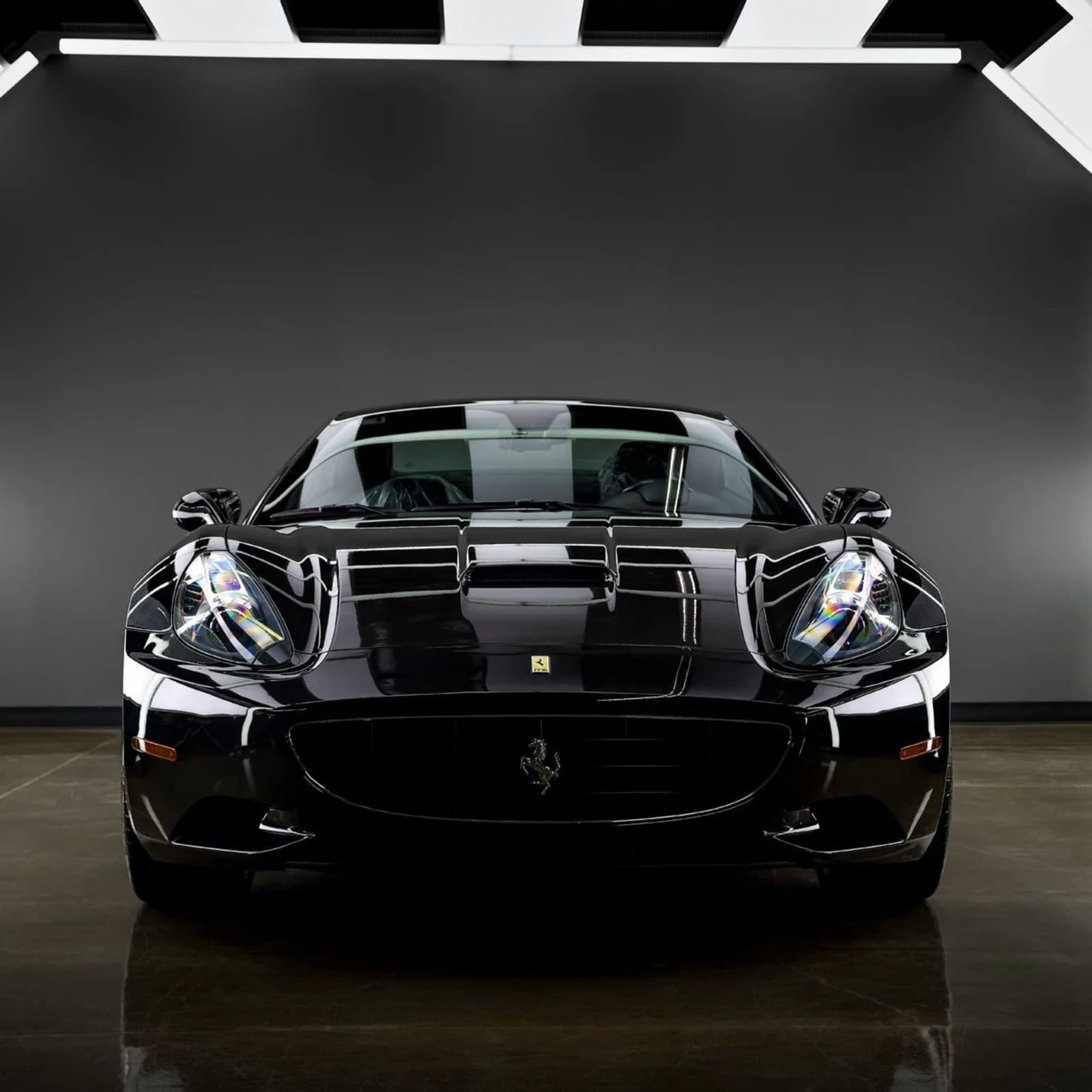 Front of a black Ferrari after paint correction and coating