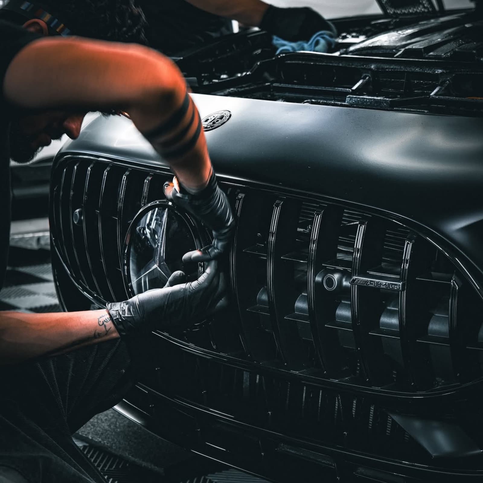 Front grille of a Mercedes cleaned out by hand, bar by bar